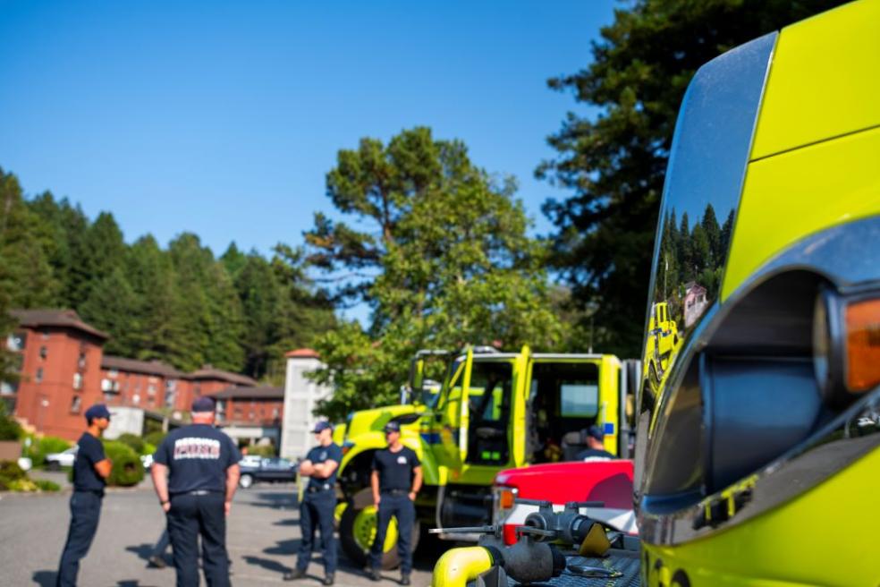 A photo of CAL FIRE firefighters in front of the Jolly Giant Commons. 