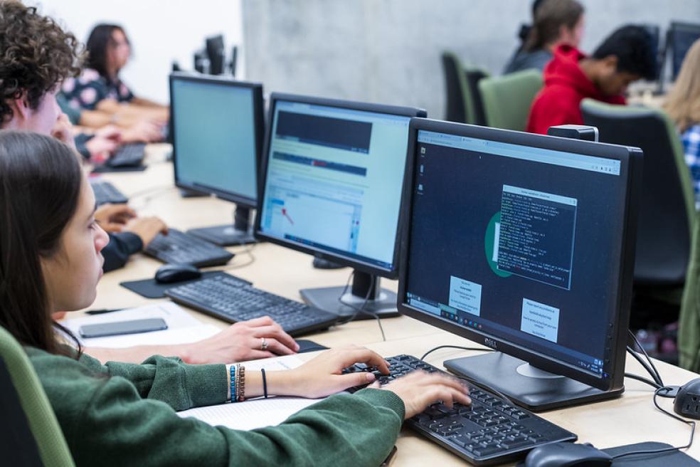 A photo of a student in front of a computer. 