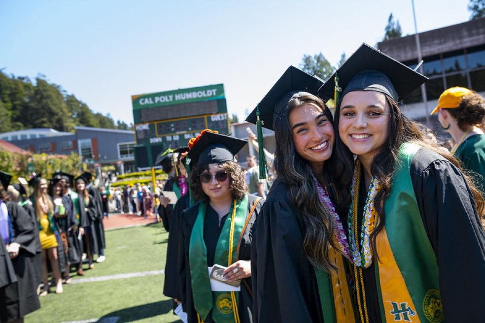 A photo of students at the Cal Poly Humboldt Commencement at the Redwood Bowl.