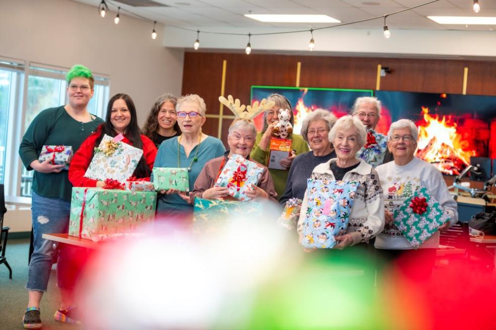 A photo of a group of volunteers wrapping presents for Winter Wishes at the Humboldt Bay Aquatic Center. 