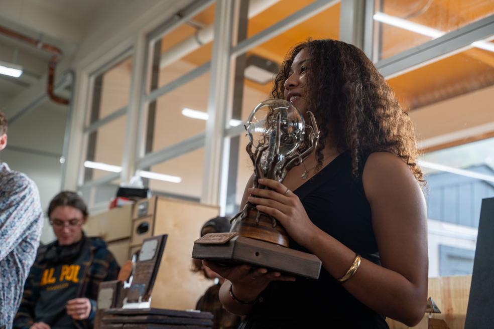 The Behavioral, Social Sciences & Public Administration trophy showcases a “Tree of Unity” with a globe at its center, symbolizing growth, collaboration, and the global impact of the fields.