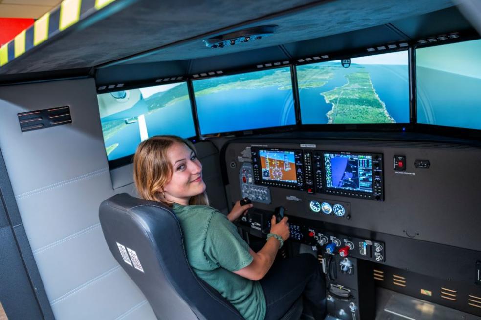 Harmony Switzer-Tryon A photo of Humboldt student Harmony Switzer Tryon using the flight simulator at the Library.