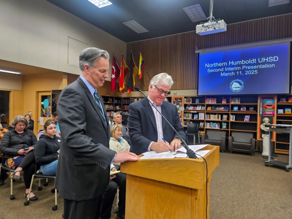 A photo of Cal Poly Humboldt Interim President Michael Spagna and Northern Humboldt Union High School District Superintendent Roger Macdonald signing the MOU for direct admissions to the University. 