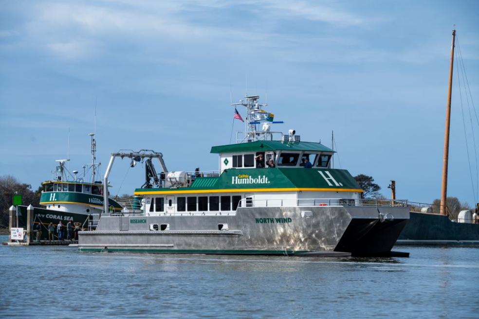 A photo of the R/V North Wind sailing into Humboldt Bay near the R/V Coral Sea. 