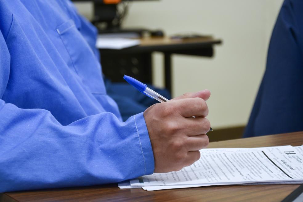 student taking notes on a resume