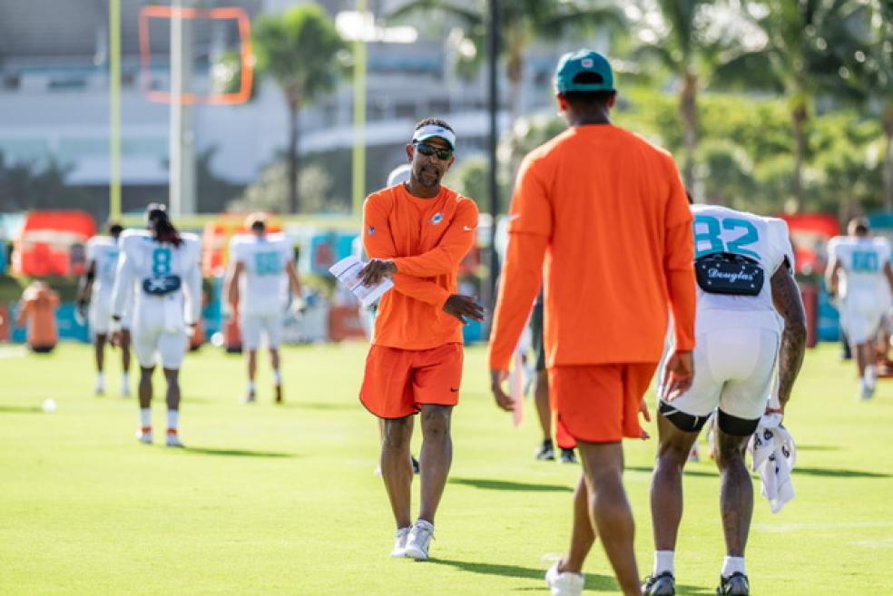 A photo of Robert Prince coaching Miami Dolphins wide receiver players during a training session.