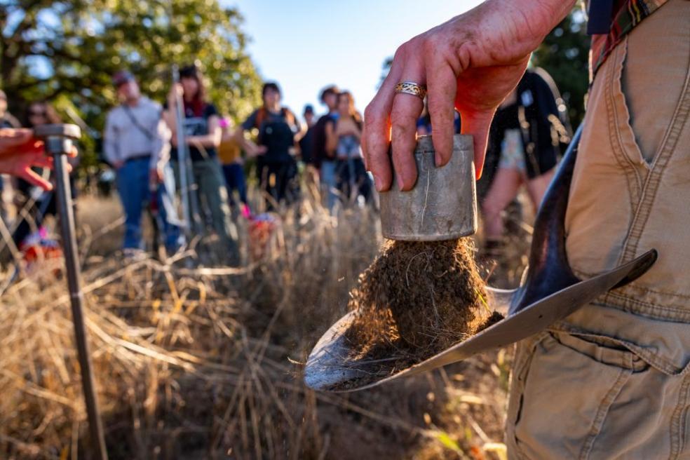 A photo of a Rangeland Resource Science field trip to Fickle Hill, in which the class is sifting through soil to analyze.
