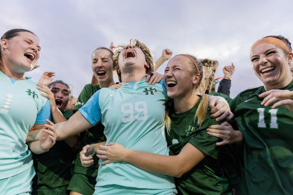members of the women's soccer team celebrating CCAA win