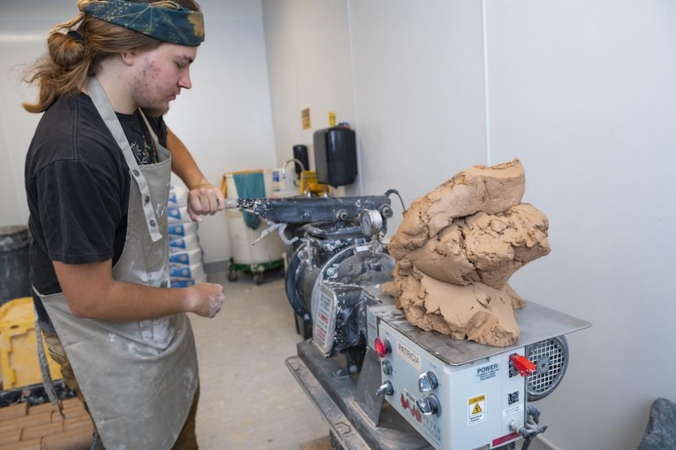 Ceramics student Liam Henslee working in the clay recycling room at Jenkins Hall 