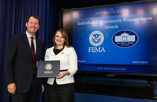 HSU Alumna Jenny Novak receiving an award from FEMA deputy administrator Tim Manning.