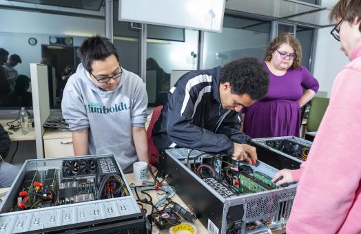 students gathered around a supercomputer 