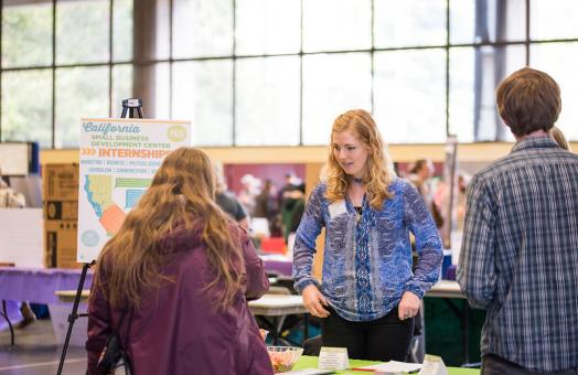 A photo of students speaking with an employer at the Career Expo