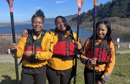 A photo of students at last year's Umoja's Black to the Land Paddle Out