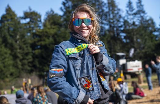 While there are usually few women who compete in logging sports, Cal Poly Humboldt’s team usually has more women than men competing, according to club members. Pictured: Elin Antaya showing off her battle jacket. 