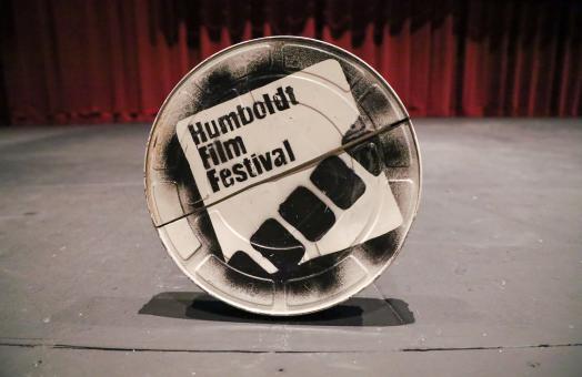 A photo of a film reel case with Humboldt Film Festival painted on the cover. 