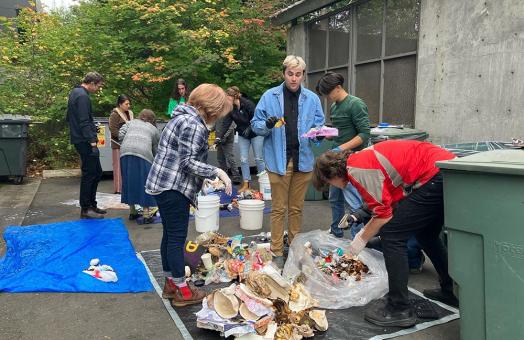 Students and participants in the Sustainability Employee Educators Developing Solutions (SEEDS) program conduct a waste audit on campus.