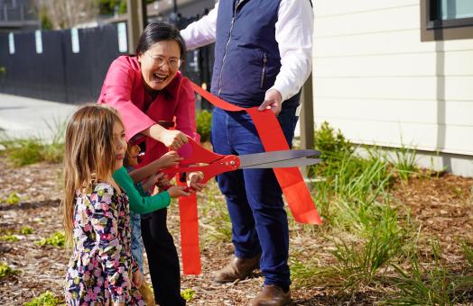 With help from Hyun-Kyung You, Cal Poly Humboldt Child Development professor and program leader for the Child Development Lab, kids cut the ribbon at the celebration of the Trinity Early Learning Center on Saturday, April 6.