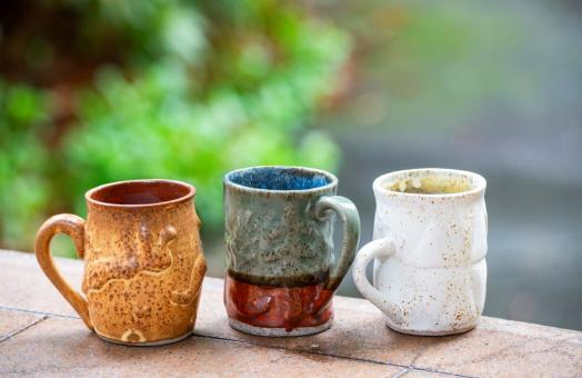 A photo of the three ceramic mugs made by Cal Poly Humboldt students to gift to donors. 