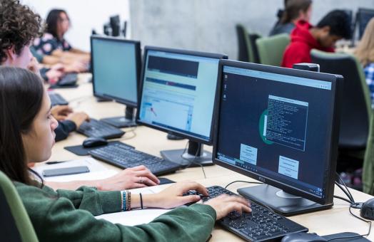 A photo of a student in front of a computer. 