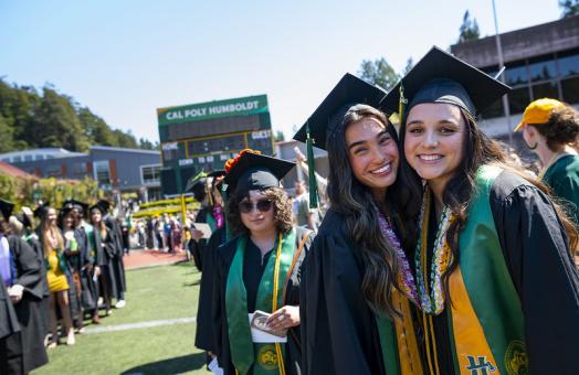 A photo of students at the Cal Poly Humboldt Commencement at the Redwood Bowl.