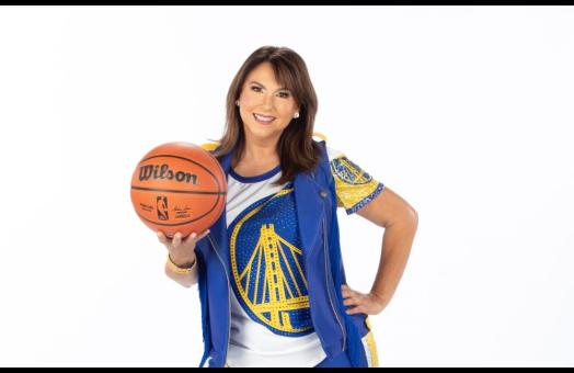 A photo of Liz Pimentel in her Golden State Warriors Hardwood Classics dance team uniform holding a basketball. 
