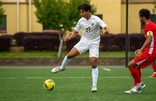 A photo of Cal Poly Humboldt Soccer Player Erwin "EJ" Manibusan playing soccer. 