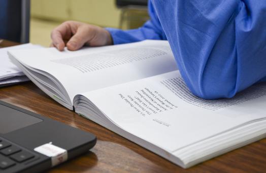 student reading from book 