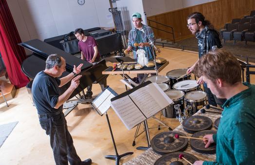 student practicing various percussion instruments 