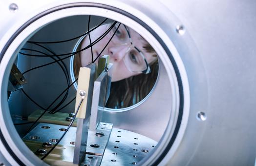 female looks through tunnel in Cal Poly Humboldt's Gravity Lab.
