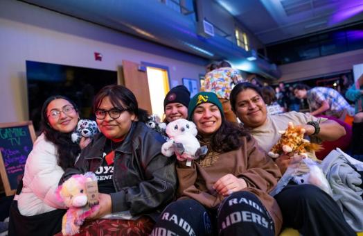 A photo of a group of students posing with their Make & Take stuffed animals at Late Night Breakfast 2023. 