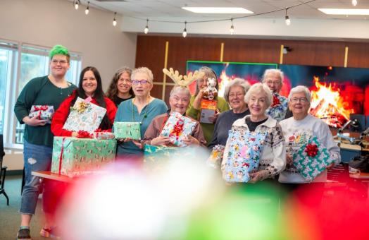 A photo of a group of volunteers wrapping presents for Winter Wishes at the Humboldt Bay Aquatic Center. 