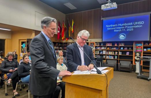 A photo of Cal Poly Humboldt Interim President Michael Spagna and Northern Humboldt Union High School District Superintendent Roger Macdonald signing the MOU for direct admissions to the University. 