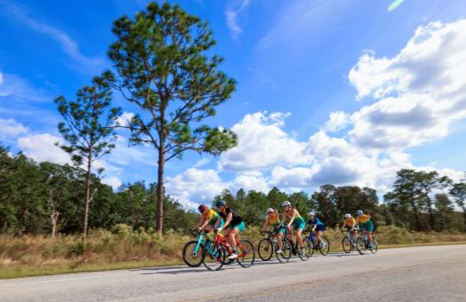 A photo of Cal Poly Humboldt's Women's Triathlon team riding bicycles. 