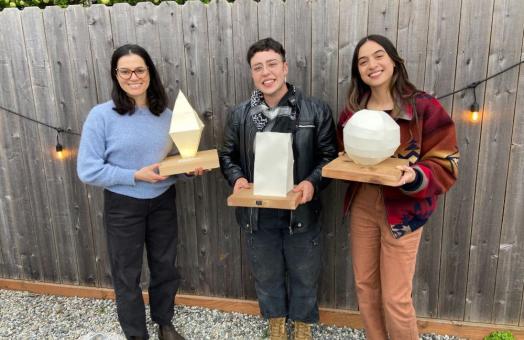 A photo (from left to right) of 2025 Sustainability Champion Award winners Cinthya Ammerman Muñoz, Karley Rojas, and Ash Hansen holding their awards. 