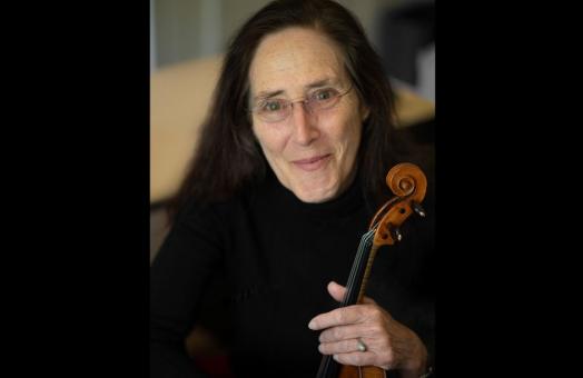 Carla Shapreau A photo of Carla Shapreau holding a violin. Photo by Max Thill
