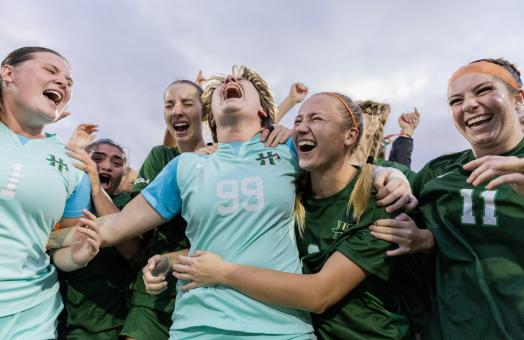 members of the women's soccer team celebrating CCAA win