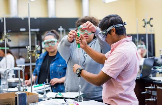 A photo of a students working in a chemistry laboratory. 