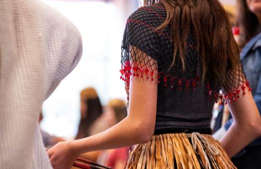 A photo of a the back of a dancer at during a Big Time event. 