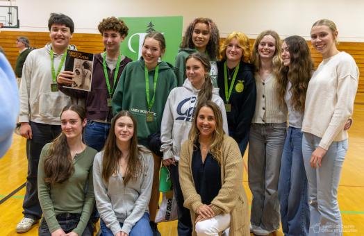 A group of students standing side by side smiling 