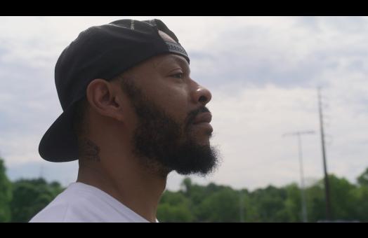 a profile of a man staring off into the distance
