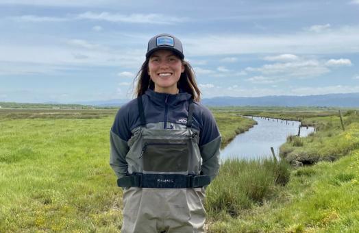 A photo of Farrah Tyler at Cannibal Island, which is a site in the Eel River Estuary that will undergo tidal marsh habitat restoration in 2027.