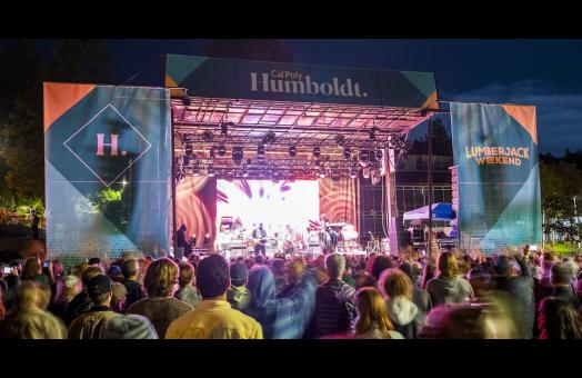 A photo of the stage and audience at Cal Poly Humboldt's Block Party. 