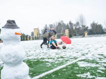 Students play in the snow in College Creek field