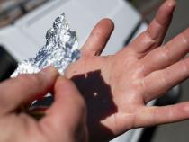Tin foil and a hand come in handy during the eclipse.