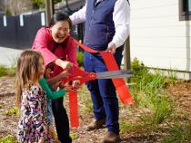 With help from Hyun-Kyung You, Cal Poly Humboldt Child Development professor and program leader for the Child Development Lab, kids cut the ribbon at the celebration of the Trinity Early Learning Center on Saturday, April 6.