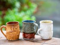 A photo of the three ceramic mugs made by Cal Poly Humboldt students to gift to donors.