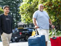 A photo of a student and family member moving in to campus residence halls.