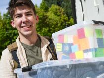 A photo of a student moving into campus residence halls.