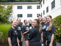 A group photo of students in front of residence halls.