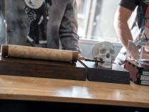 The trophies for the Humanities and Letters category winners include a skull with a letter opener, and scroll and scroll holder, calling back to ancient texts.